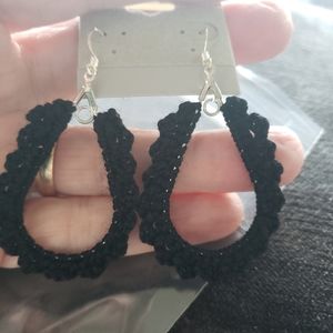 Hand crocheted earrings in black with silver ear wires.